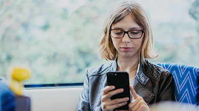 Woman using mobile phone on the train